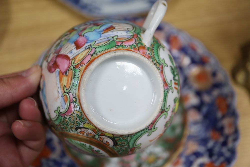 A collection of mixed Chinese and Japanese porcelain and pottery including a Nanking Cargo blue and white tea bowl, a 19th century